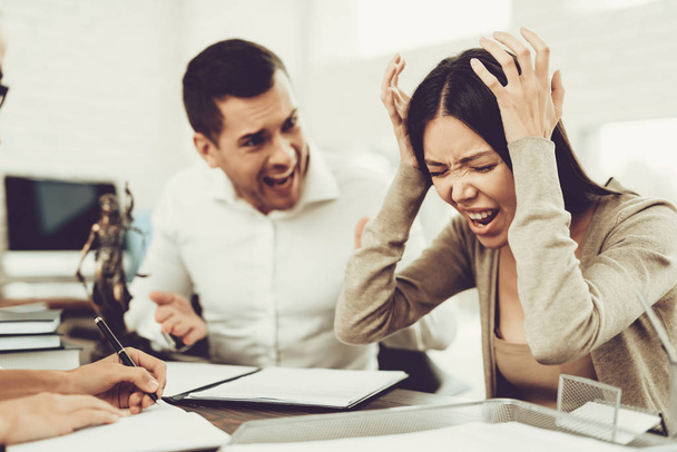 Upset Husband and Angry Wife in Office with Lawyer. Frustrated Husband. Problem in Relationship between People. Modern Law Office. Angry Young Wife. Marriage Problem. Young Advocate. - Photo, Image