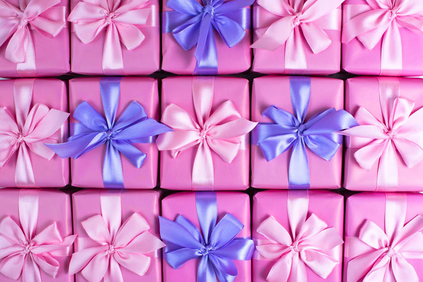 Rows of boxes with gifts decoration ribbon satin bow pink. A top view of Flat lay - Photo, Image