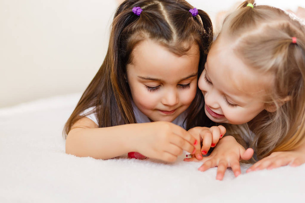 Due bambine si sono dipinte le unghie a casa.
. - Foto, immagini