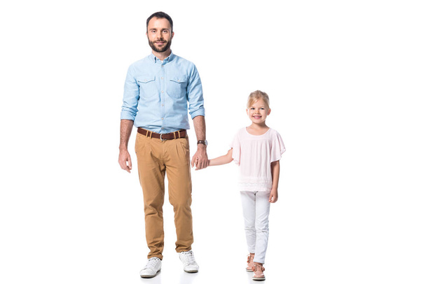 father and daughter holding hands and looking at camera isolated on white - Photo, Image