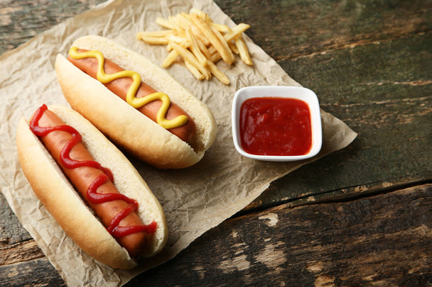 Hot dogs with mustard and ketchup on wooden table - Photo, Image