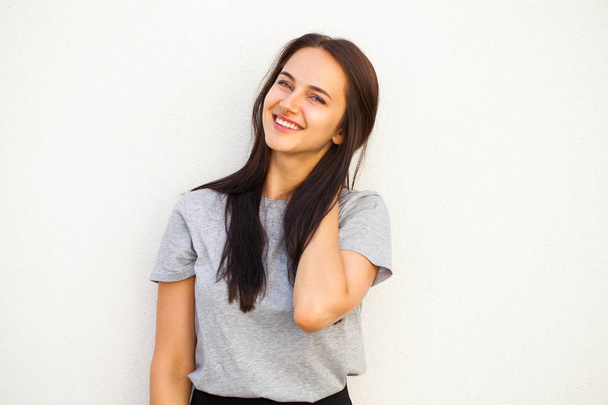 Happy Beautiful brunette woman in gray t-shirt, isolated on white wall background - Foto, imagen
