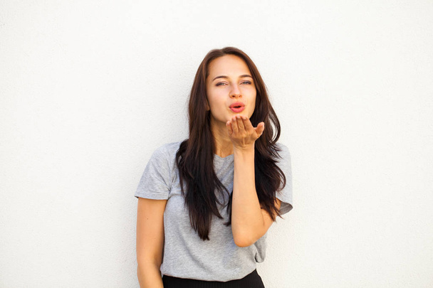 Blow kiss, young caucasian female brunette model, isolated on white background  - Valokuva, kuva