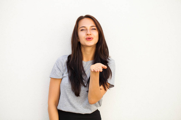 Blow kiss, young caucasian female brunette model, isolated on white background  - Foto, Imagem
