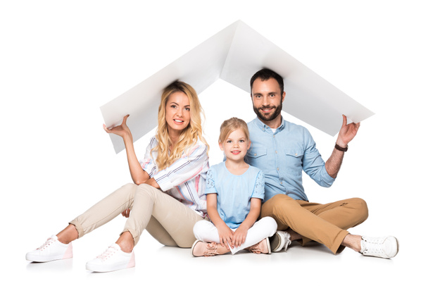 parents with daughter holding white roof over heads isolated on white, family insurance concept - Photo, Image