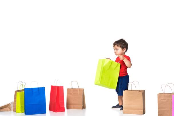boy holding shopping bag isolated on white .  - Фото, изображение
