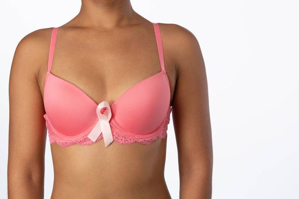 Standing woman for breast cancer awareness with ribbon on white background - Φωτογραφία, εικόνα