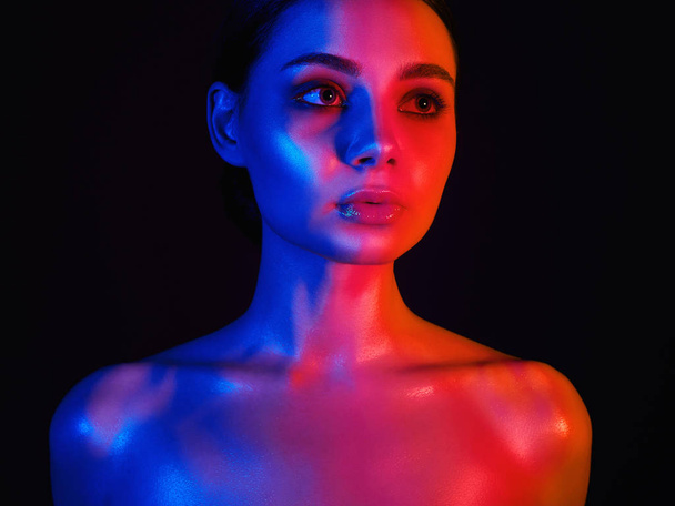 Beauty Rainbow woman. Beautiful Girl in red and blue bright lights - Foto, imagen