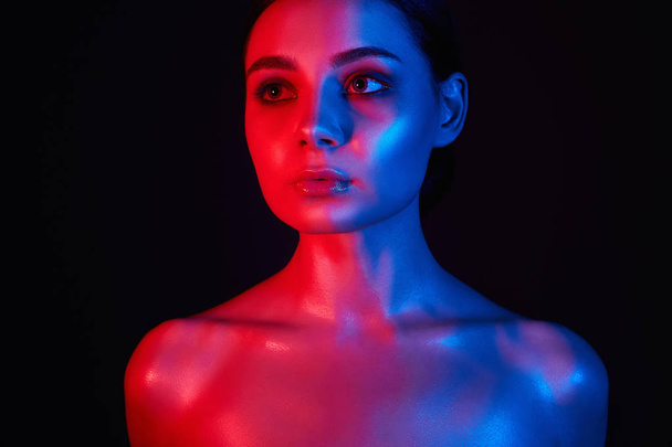 Beauty Rainbow woman. Beautiful Girl in red and blue bright lights - Foto, afbeelding