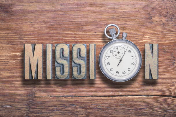 mission word combined on vintage varnished wooden surface with stopwatch inside - Photo, Image