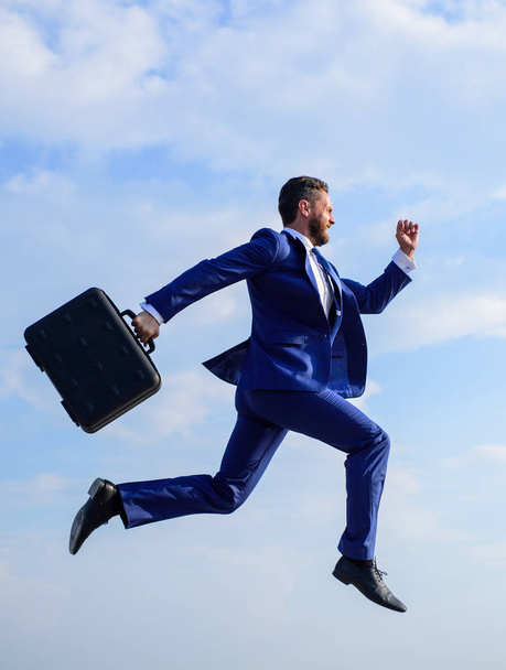 Businessman formal suit make effort to succeed. Supernatural power. Success in business demands supernatural efforts from entrepreneur personality. Businessman with briefcase jump high motion forward - Valokuva, kuva