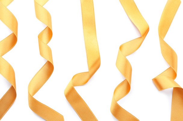 Golden satin ribbons on white background - Photo, Image