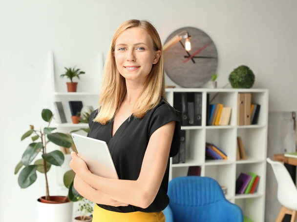 Young businesswoman with tablet PC in office - Zdjęcie, obraz