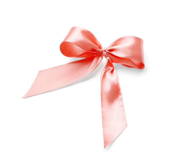 白い背景の上のピンクのリボンから作られた美しい弓 - 写真・画像