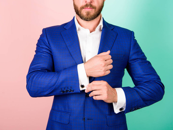 Make sure outfit and appearance look perfect. Details make outfit elegant. Male fashion. Perfect to last detail. Man well groomed businessman with beard strict face check button on shirt sleeve - Photo, Image