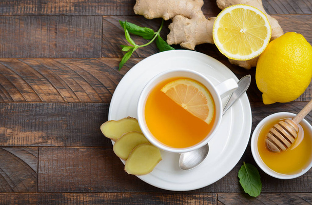 Ginger root tea with lemon and honey on wooden background, top view, copy space. - Photo, Image