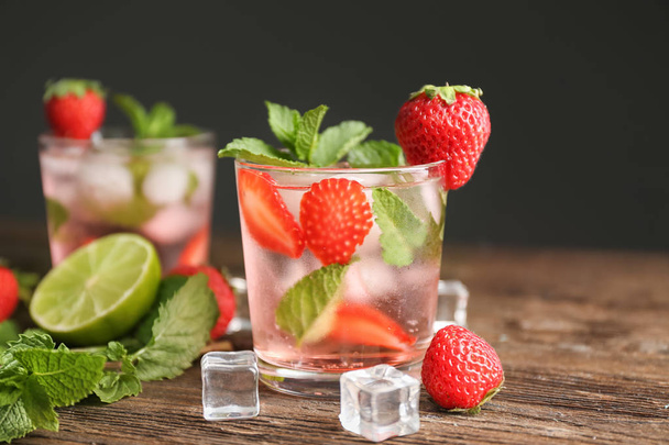 Glass of fresh strawberry mojito on wooden table - Photo, Image