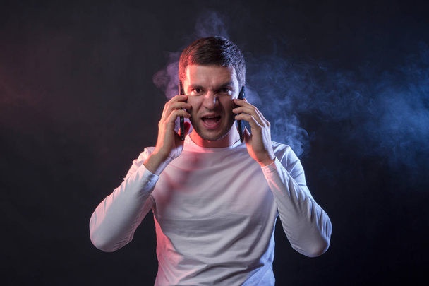 Financial adviser on securities screams in two phones. The concept of a stock market crash, the depreciation of securities and currencies - Photo, Image