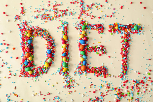 Word DIET made of color candies on light background - 写真・画像