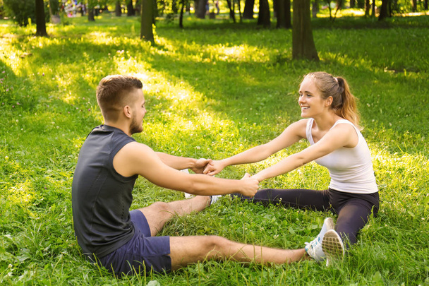 Sporty young couple training outdoors - 写真・画像