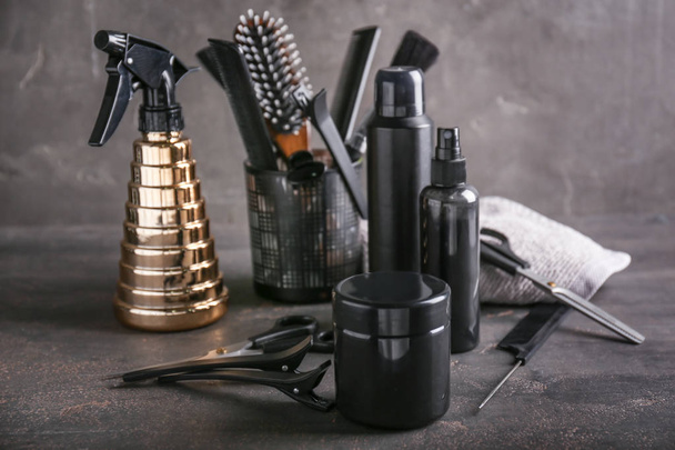 Professional hairdresser's set with cosmetics on grey table - Fotó, kép