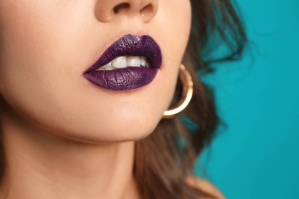 Beautiful young woman with dark lipstick on color background, closeup - Fotoğraf, Görsel
