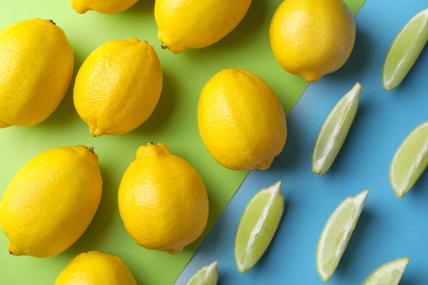 Ripe lemons with sliced lime on color background - Foto, Imagem