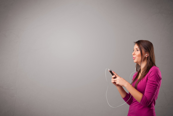 young lady singing and listening to music with copy space - Photo, Image