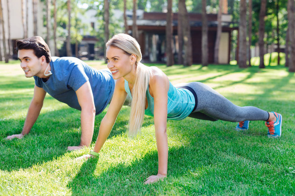 Positive healthy couple having an outdoor workout - Фото, зображення