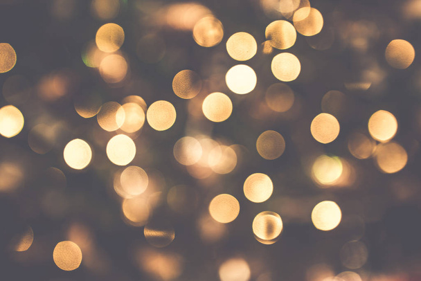 Golden Christmas bokeh lights glittering in orange colors in the holidays - Photo, Image