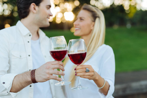 Glasses with red wine being clinked together - Fotografie, Obrázek