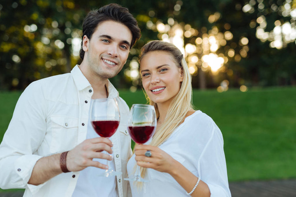 Happy nice young couple drinking red wine together - Photo, image