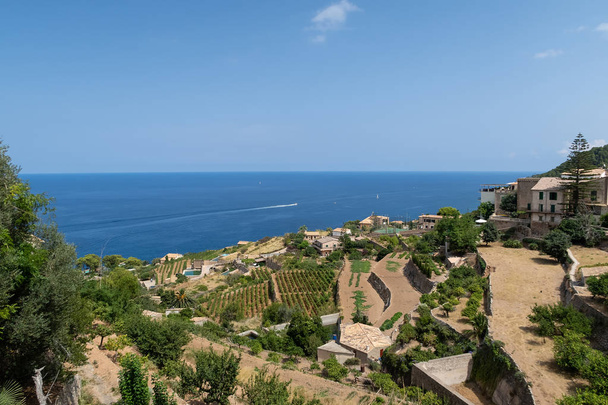 historic village of Banyalbufar on Mallorca, Spain against blue sky and sea - Фото, изображение