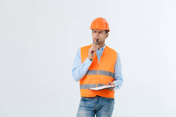 Portrait of Serious architect or engineer writing or taking notes on a clipboard isolated on white background - Photo, Image