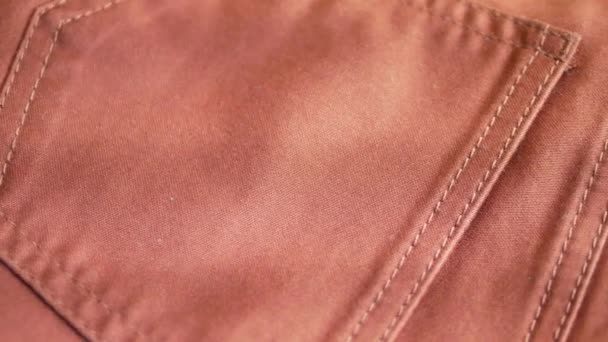 Pomarańczowym tkaniny tekstylne spodnie z kieszeniami - Materiał filmowy, wideo
