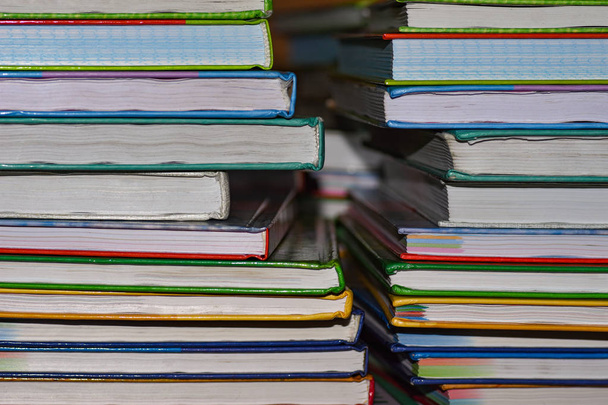 School books lie in two piles on the table - Photo, Image