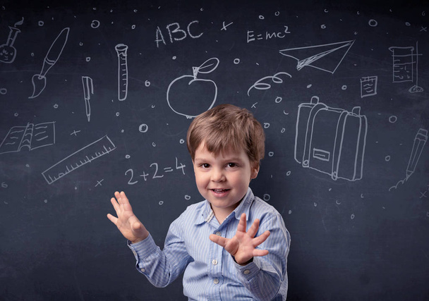 Little boy in front of a drawn up blackboard - Фото, зображення