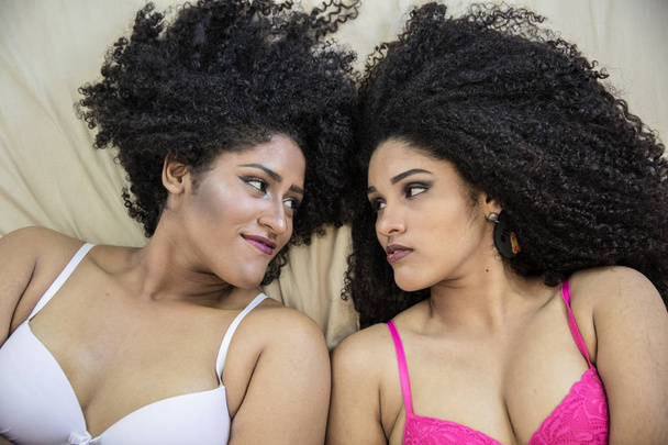 Two young afro girls having fun together, joy, positive, love, friendship, sisters. Happy meeting of two friends hugging. Lesbian concept. - Foto, Bild