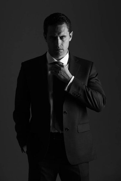 Successful man adjusting tie in stylish blue formal suit - Fotoğraf, Görsel