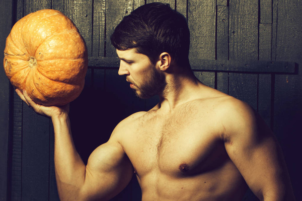 Muscular man with pumpkin - Fotó, kép
