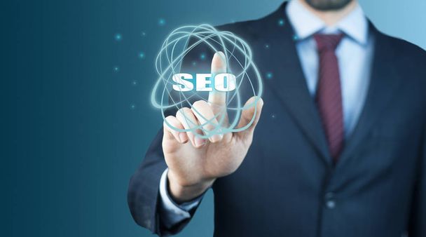 Business man touching  SEO text on screen - Photo, image