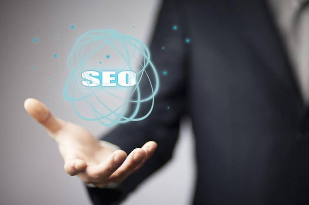 Business man holding SEO icon. Business concept - Photo, image