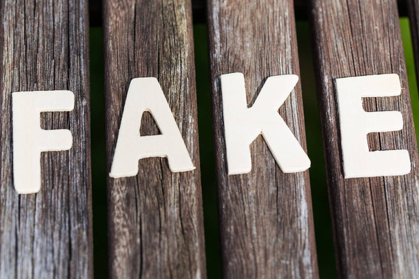 Fake, fact, as text, letters on wood - Φωτογραφία, εικόνα