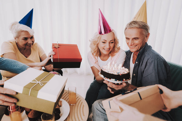 Old Couple Celebrating Birthday before Departure. Senior Person in Airport. Tourism Concept. Old Couple in Voyage. Celebrating Birtsday. Vacation for Pensioner. Travelers on Vacation. - Photo, Image