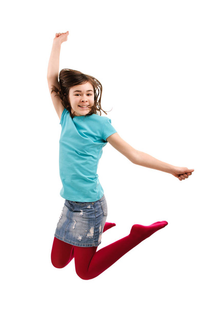 Teenage girl in bright clothes jumping isolated on white background - Fotoğraf, Görsel