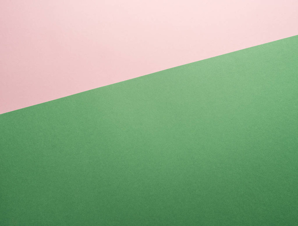 Paper background of two colors green and pink. - Foto, Bild