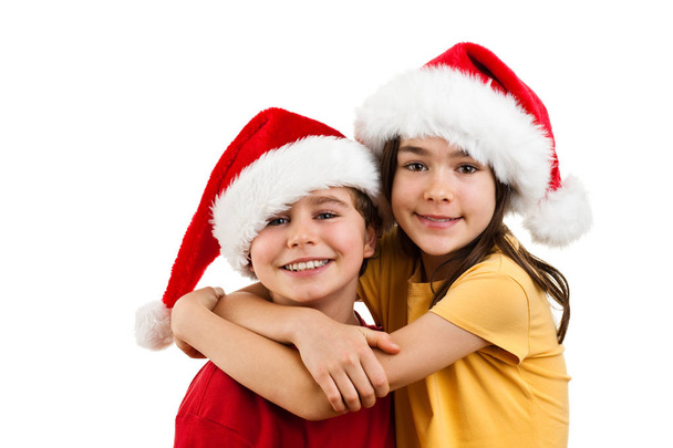 Boy and girl in Santa's hats - Photo, image