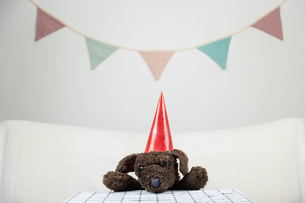 Children party concept with fluffy toy dog at the table - Photo, Image