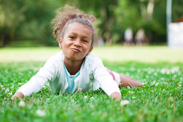 Close up portrait of pretty mixed race African-American little girl, summer park outdoors - Zdjęcie, obraz