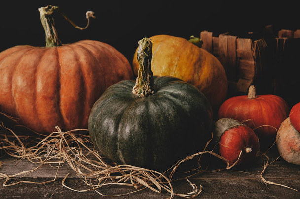 pumpkins on wooden table with hay, halloween concept - Foto, imagen